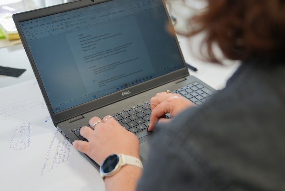 Woman typing on a laptop.  