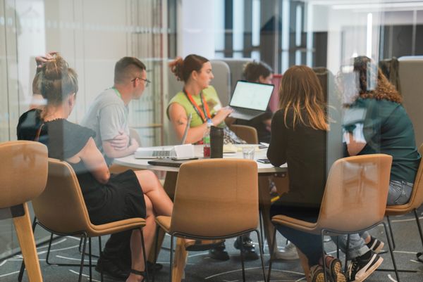 Six people doing group work in an office.